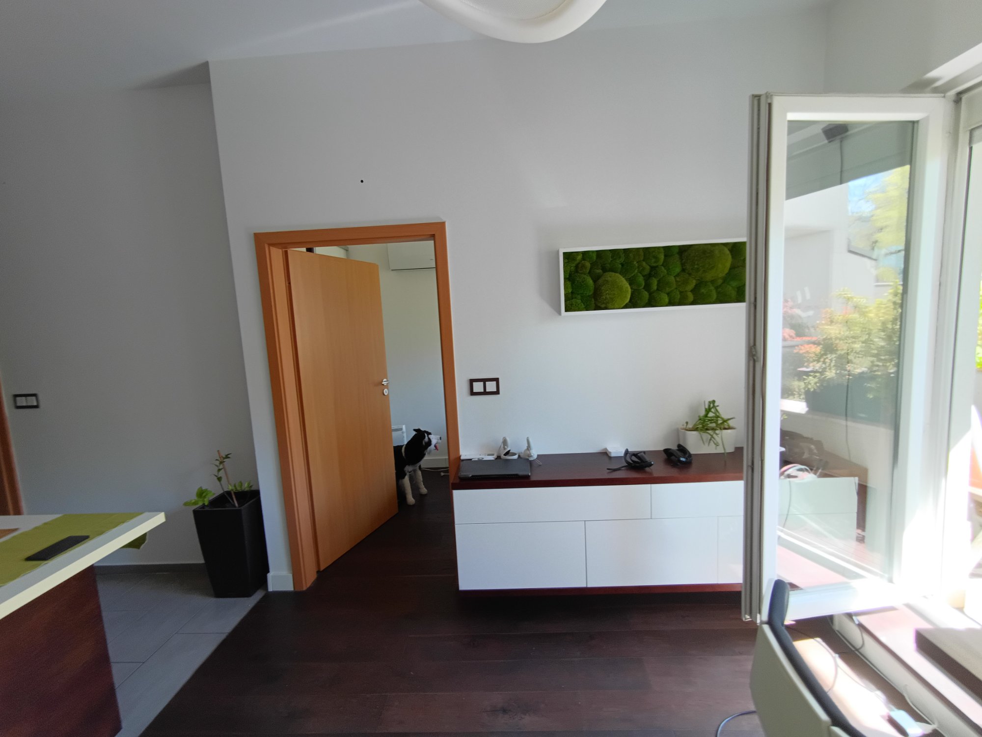 Living room with moss wall art and white sideboard
